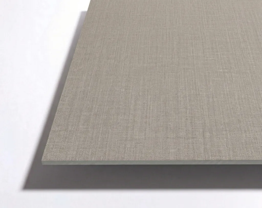A close-up view of a rectangular, light-gray textured panel resting on a white surface, casting a slight shadow underneath.