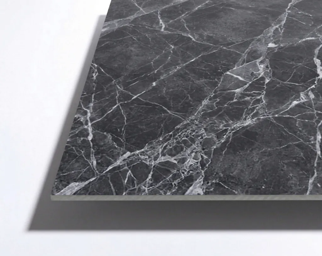 A rectangular slab of black marble with prominent white veining is displayed against a plain light background.
